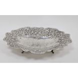 White metal shaped oval bowl with floral and scrolling decoration, on four bracket feet, marked 925,