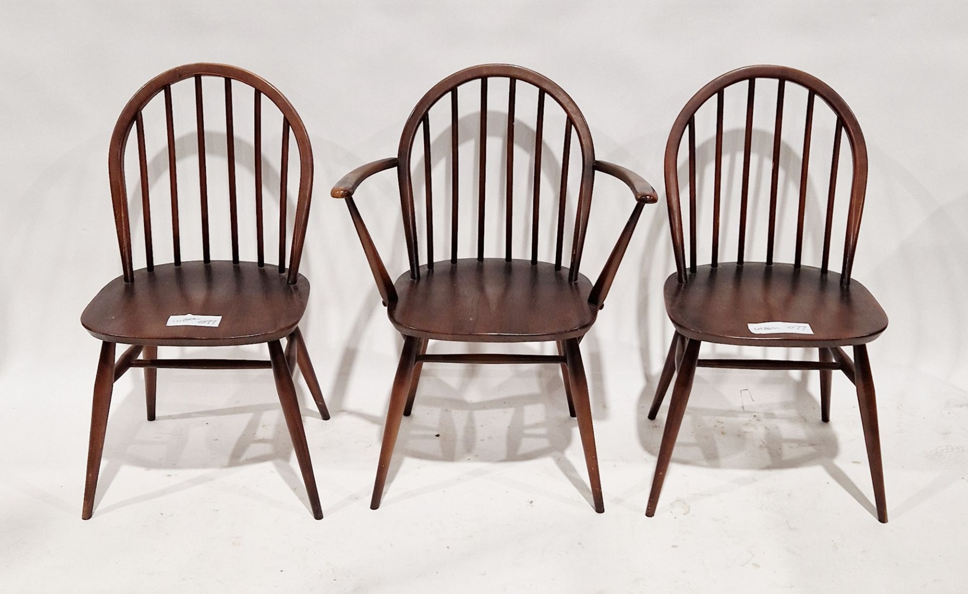 Set of three stained Ercol Windsor-style dining chairs, one being a carver, 82cm high (3)