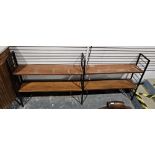 Mid century Ladderax two-section shelving unit comprising three black painted metal frames and