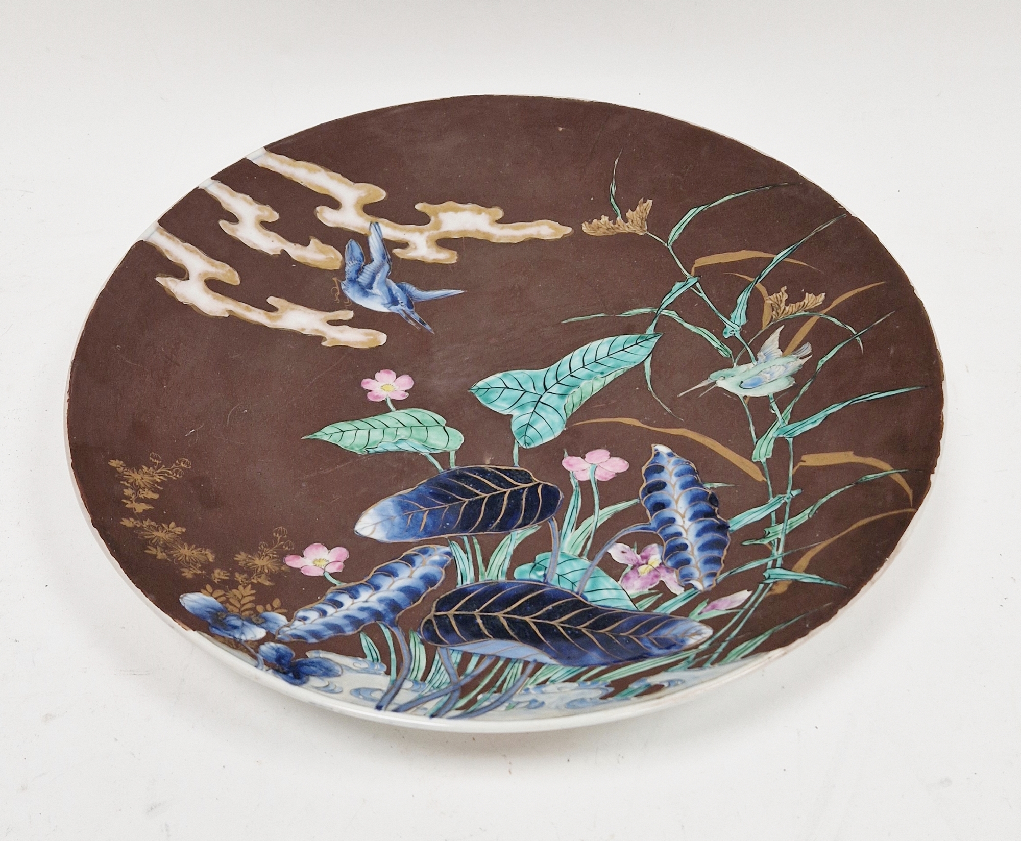 Early 20th century Japanese porcelain charger, painted in underglaze blue with water plants and