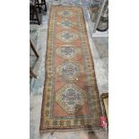 Eastern green ground runner with six central octagonal medallions, multiple floral and geometric