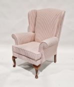 20th century upholstered wing back armchair on wooden legs, 100cm high