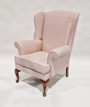 20th century upholstered wing back armchair on wooden legs, 100cm high