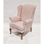 20th century upholstered wing back armchair on wooden legs, 100cm high