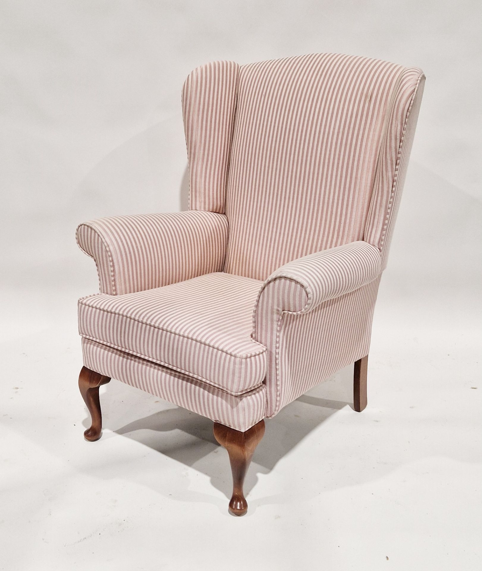 20th century upholstered wing back armchair on wooden legs, 100cm high