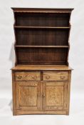 Oak Welsh dresser with two-tier platerack over two short drawers and a two-door cupboard, brass