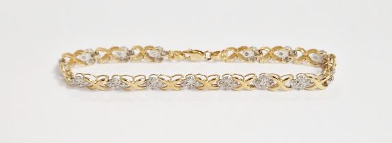 10K gold and diamond bracelet having four diamond chips, illusion set, interspersed by 'X' links