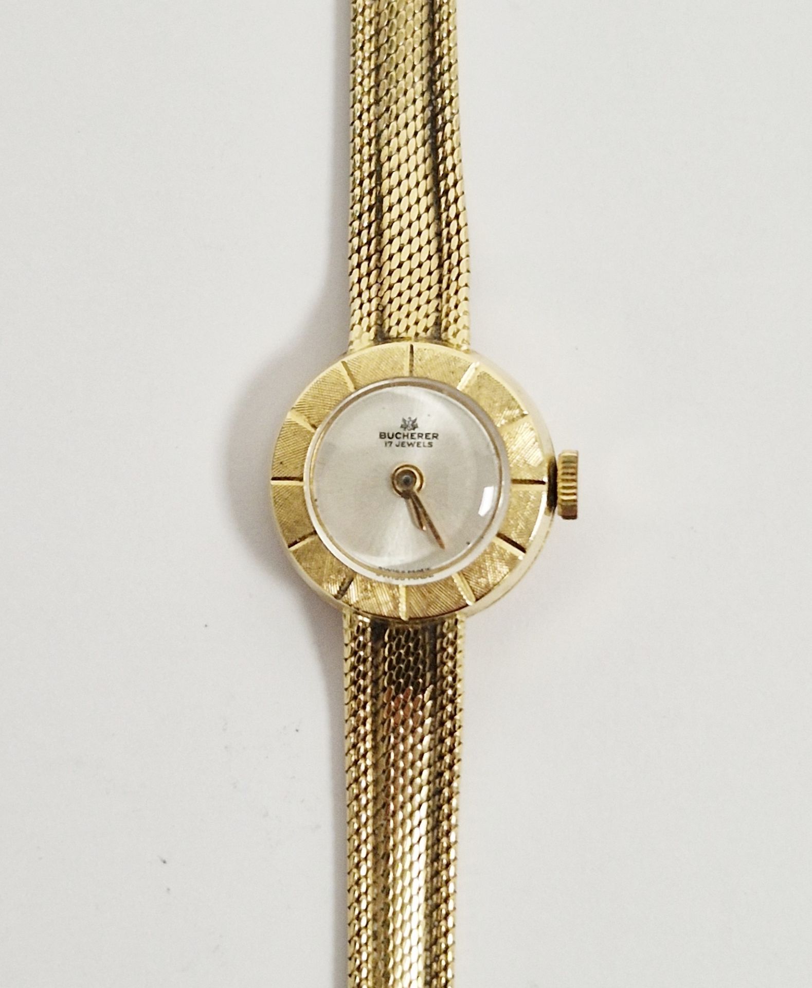 Bucherer lady’s 18ct gold wristwatch, the circular dial with engine-turned border, on woven mesh