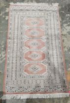 Silk cream ground rug with five central lozenges enclosed by octagonal medallions, multiple