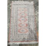 Silk cream ground rug with five central lozenges enclosed by octagonal medallions, multiple