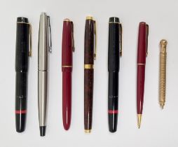 Collection of vintage fountain pens, including a Parker example with 18K nib and a Hicks Patent