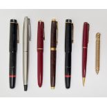 Collection of vintage fountain pens, including a Parker example with 18K nib and a Hicks Patent