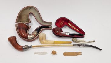 Three early 20th century silver-mounted pipes, one bone mounted, another pipe and a naval whistle