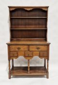 Oak Welsh dresser with three-tier platerack over five drawers of various sizes, over a further