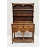 Oak Welsh dresser with three-tier platerack over five drawers of various sizes, over a further