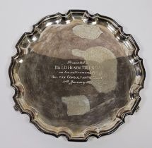 Silver salver, circular with serpentine border and inscription to “Dr I D Heath” to the front, on