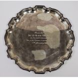 Silver salver, circular with serpentine border and inscription to “Dr I D Heath” to the front, on