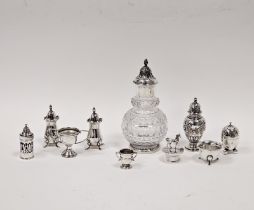 A collection of five silver pepperettes, including Walker & Hall, Sheffield 1938; Deakin &