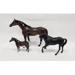 Three Beswick pottery models of horses comprising a large chestnut coloured horse, 35cm long,