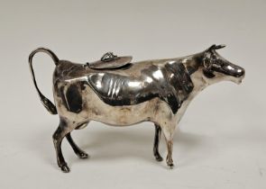A Elizabeth II silver cow creamer, the hinged lid applied with a fly finial, the tail forming a