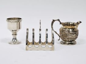 Early 20th century silver four-slice toast rack, an embossed silver cream jug and a silver egg cup