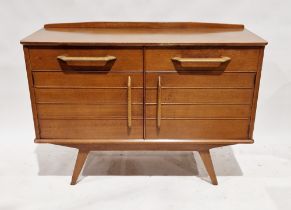 Mid century teak G-Plan E. Gomme sideboard having two short drawers over a two-door cupboard, raised