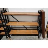 Mid century Ladderax three-section shelving unit comprising three black painted metal frames and six