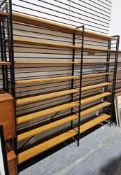 Mid century Ladderax three-section shelving unit comprising three black painted metal frames and