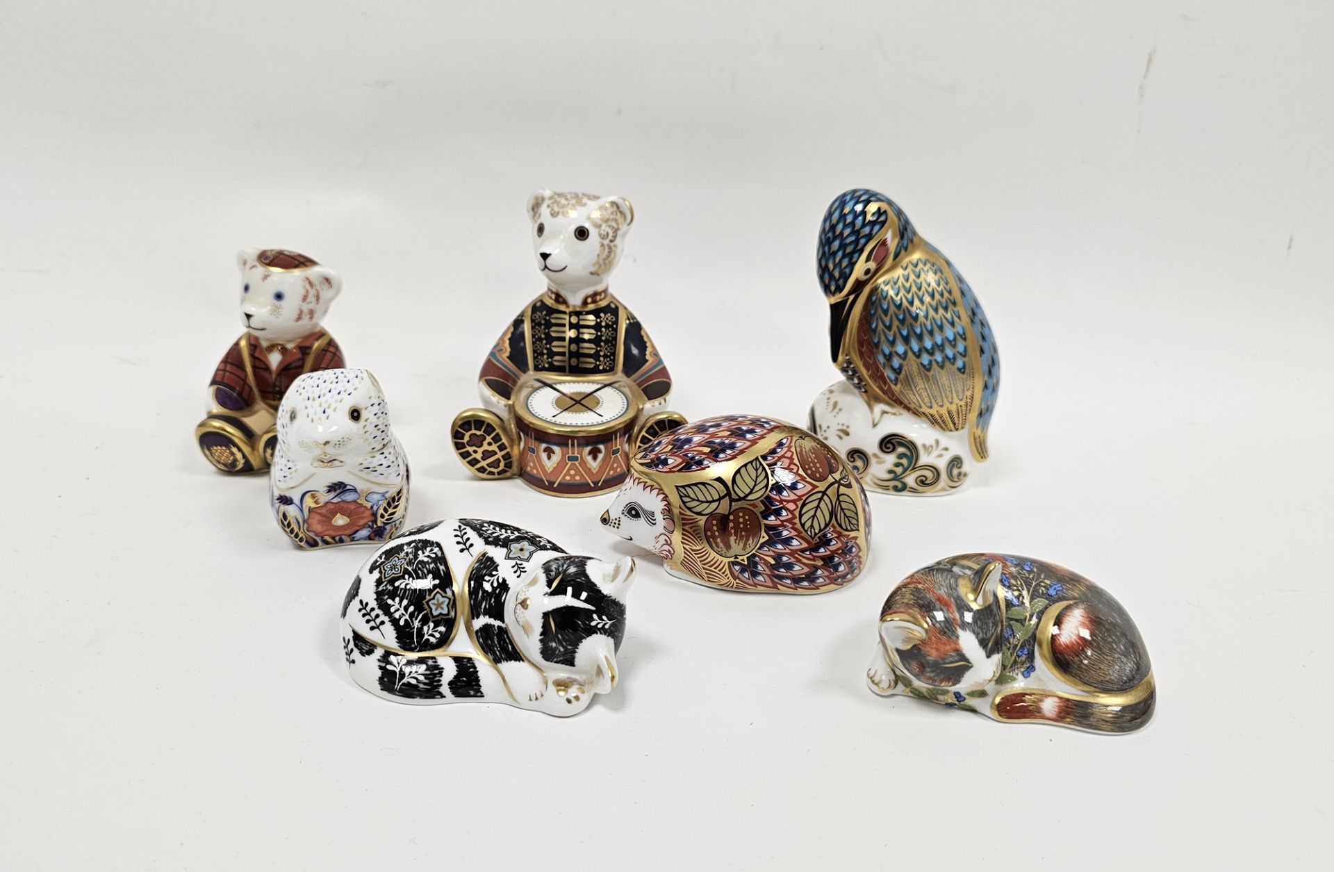 Seven Royal Crown Derby bone china animal paperweights, comprising Drummer Bear, Orchard Hedgehog,
