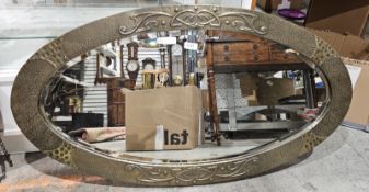Art Nouveau hammered brass framed oval wall mirror, bevelled edge, 95cm x 52cm