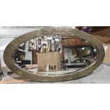 Art Nouveau hammered brass framed oval wall mirror, bevelled edge, 95cm x 52cm