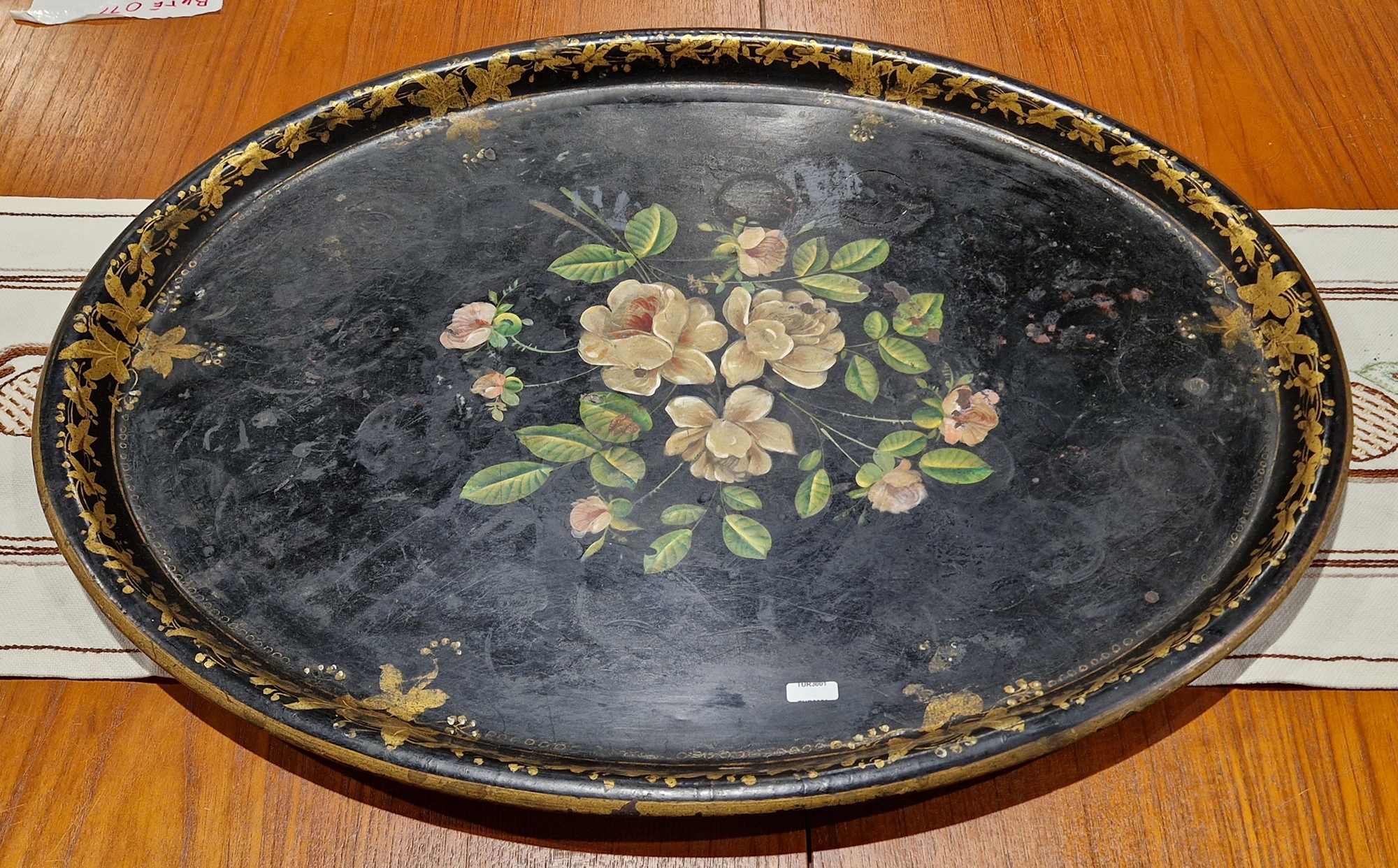 Victorian black lacquered oval tray, decorated with painted and gilt motif (74 x 59cm)