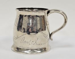 Early 20th century Indian silver-coloured metal presentation mug with slight everted rim, scroll