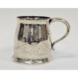 Early 20th century Indian silver-coloured metal presentation mug with slight everted rim, scroll