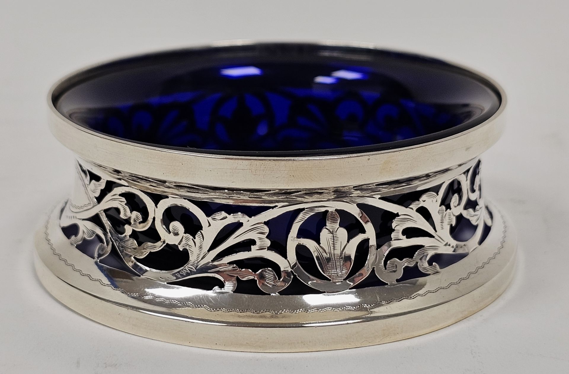 George V silver miniature dish ring of typical waisted form and pierced with foliate scrolls and two - Image 2 of 4