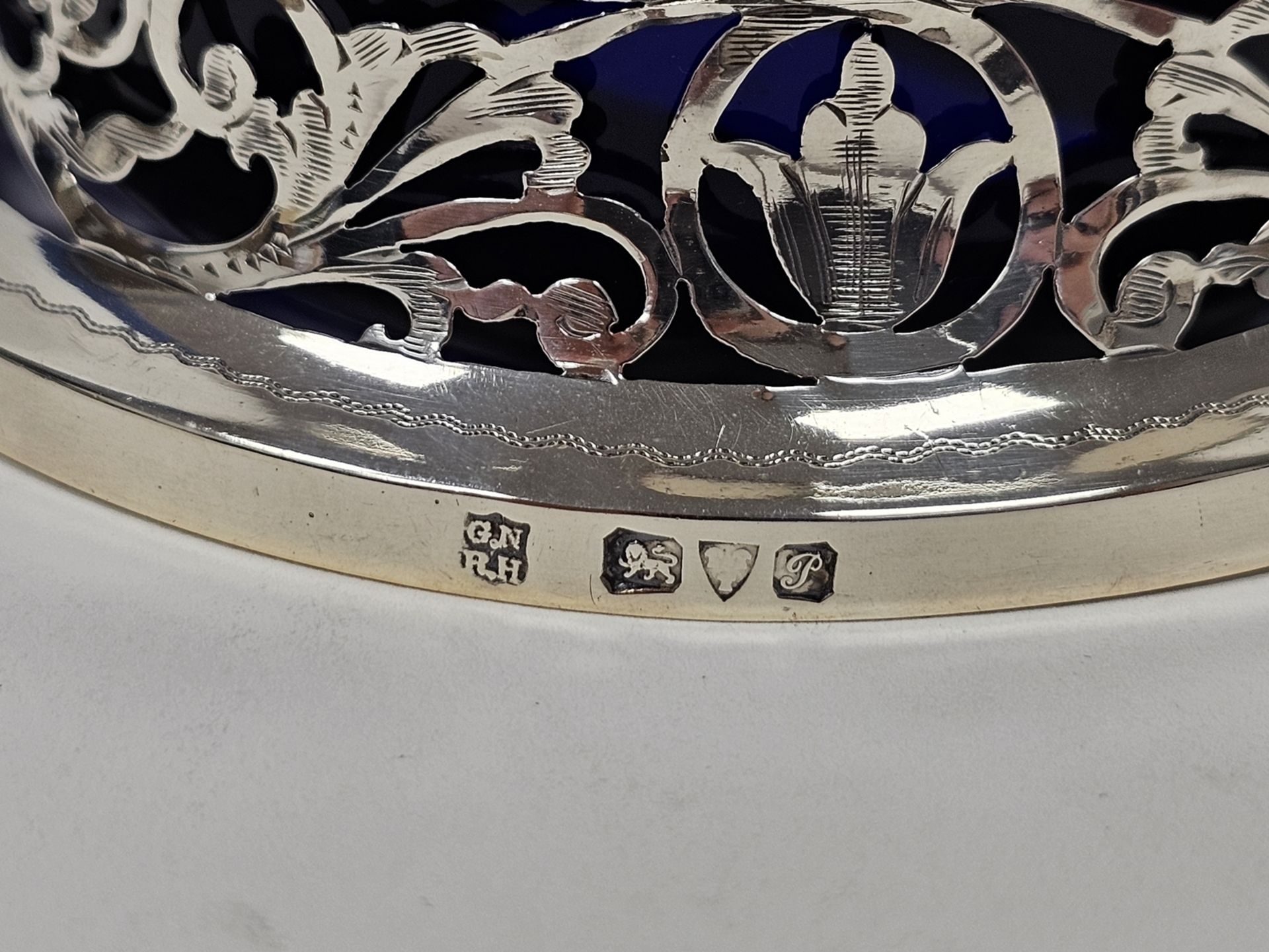 George V silver miniature dish ring of typical waisted form and pierced with foliate scrolls and two - Image 4 of 4