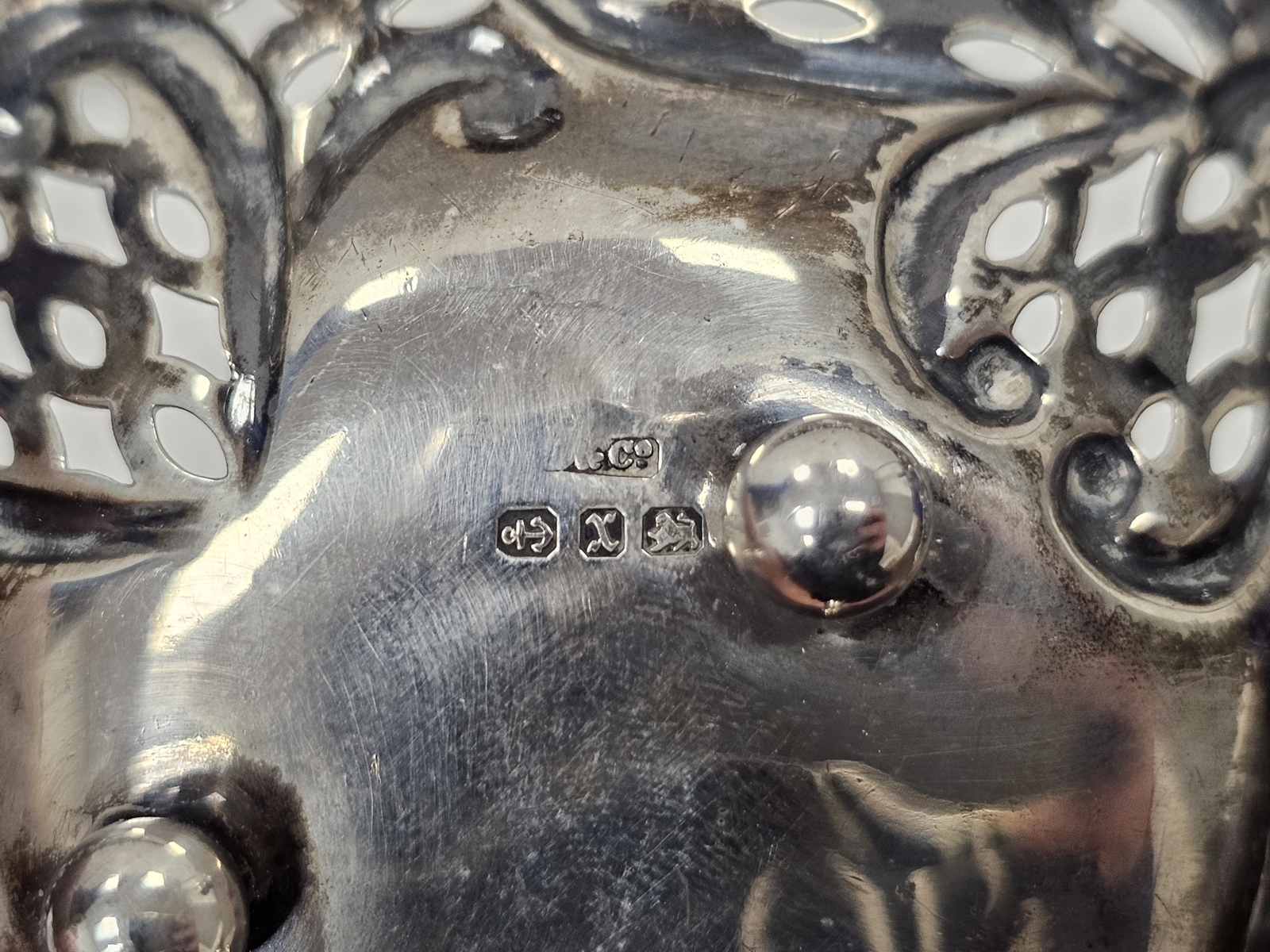 A pair of Victorian silver pierced circular bonbon dishes, embossed with heart motifs, raised on - Image 4 of 4