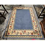 Modern blue ground rug with plain blue field, single floral and geometric borders, 170cm x 120cm