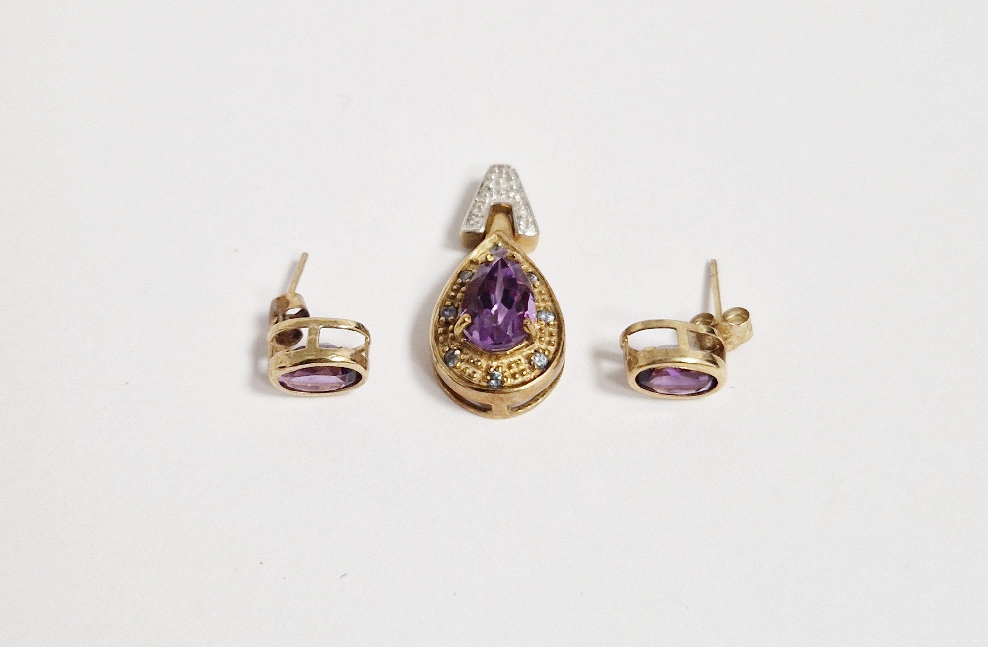 9ct gold, amethyst, diamond and blue stone pendant, the pear-shaped amethyst with blue stone set