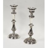 Pair of Elizabeth II silver candlesticks embossed scrolling and acanthus motifs, Birmingham 1966