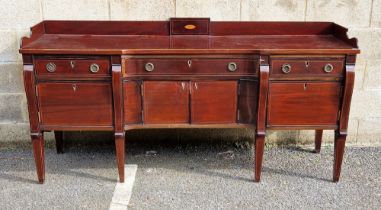 Early 19th century mahogany breakfront sideboard, the centre drawer with D-shaped concave front