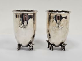 Pair Italian silver-coloured metal goblets, circular and tapering on two dachshund supports,