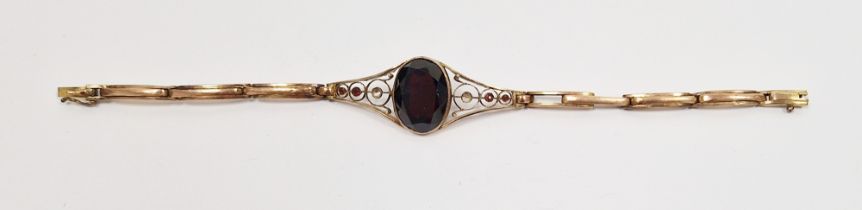 LOT WITHDRAWN 9ct gold and garnet bracelet set oval cut stone with scroll shoulders, having small