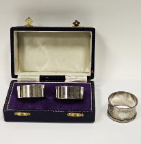 Pair of modern silver napkin rings by Da-Mar Silverware, London 1977, in fitted case and one other