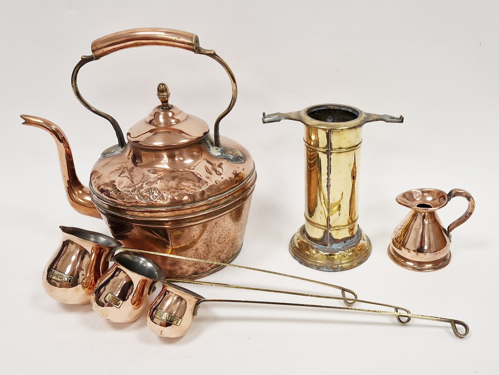 Victorian copper kettle, a brass half-gill measuring jug, three copper and brass spirit warmers
