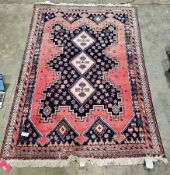 Large Iranian dark blue ground rug with three central lozenges enclosed in a geometric medallion