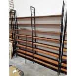 Mid century Ladderax three-section shelving unit comprising three black painted metal frames and