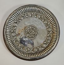 Indian white metal dish of circular form with floral decoration within a gadrooned border, 20cm