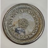 Indian white metal dish of circular form with floral decoration within a gadrooned border, 20cm