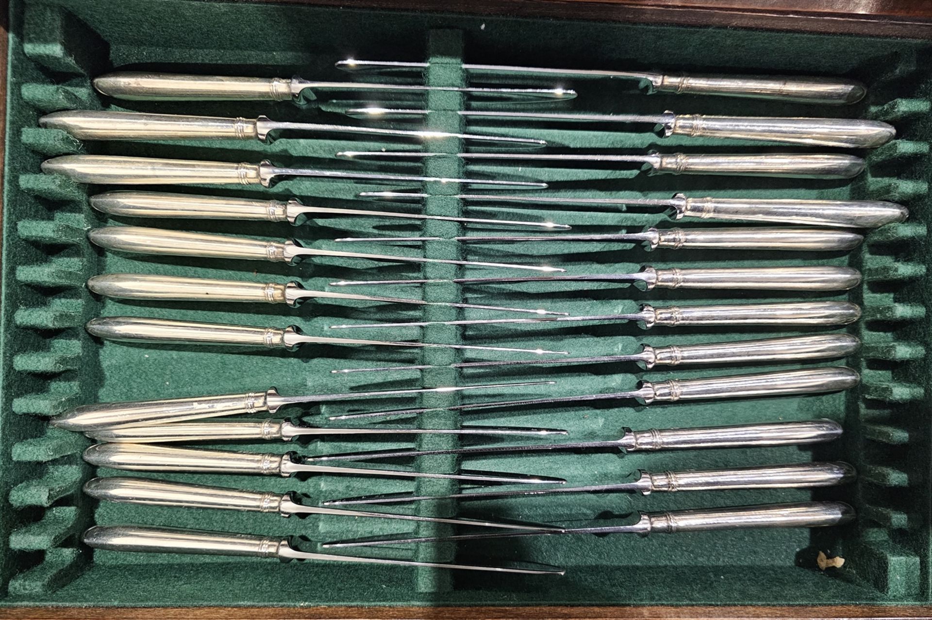 A large matched set of Victorian silver flatware for twelve, including table knives, forks, spoons